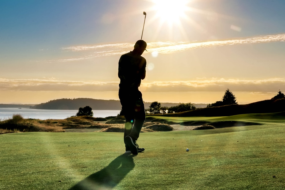 Dungeness Golf Course, photo of a man golfing near our Olympic Peninsula Lodging